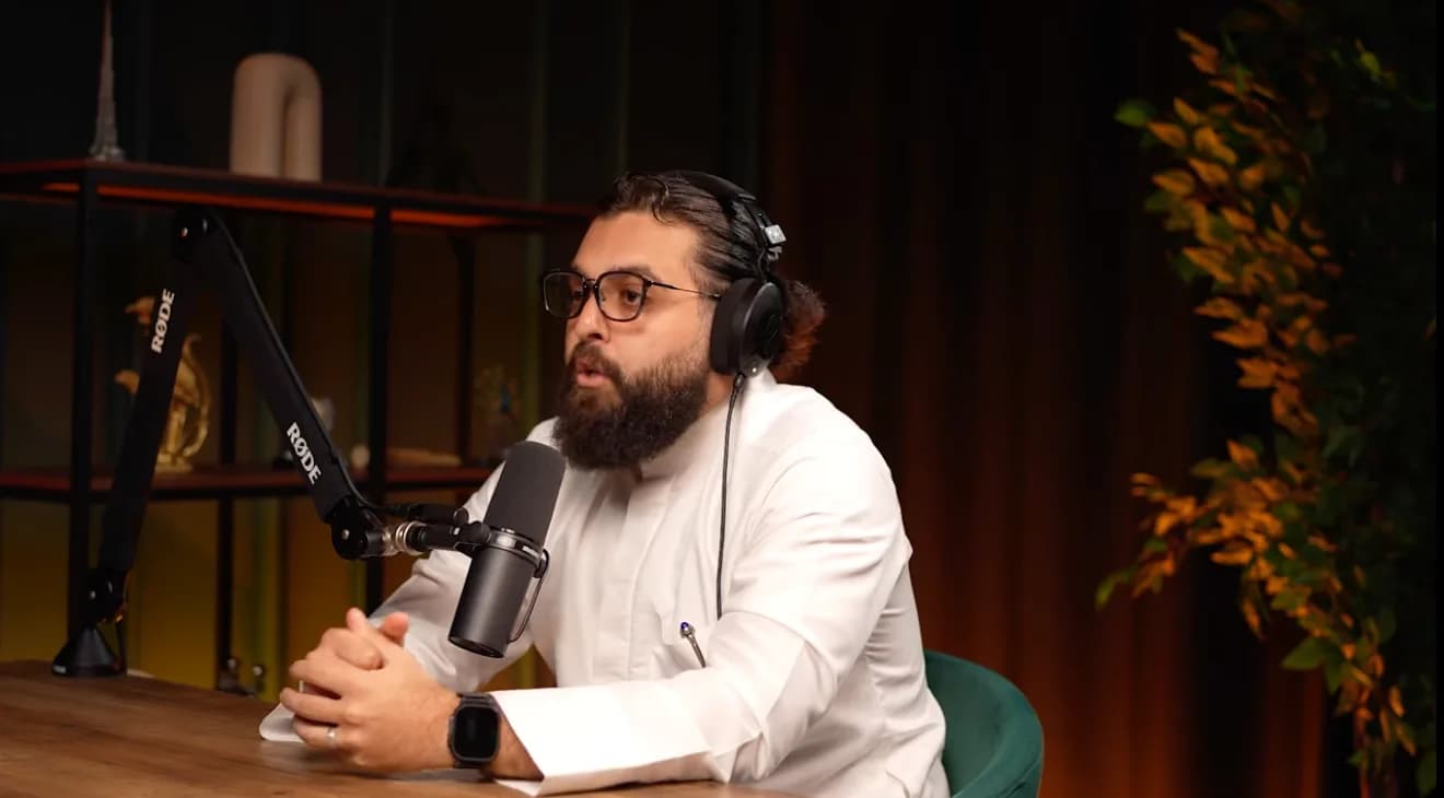 Ibrahim Shareef, in glasses and headphones, speaking into a studio microphone while recording The Barakah Blueprint
